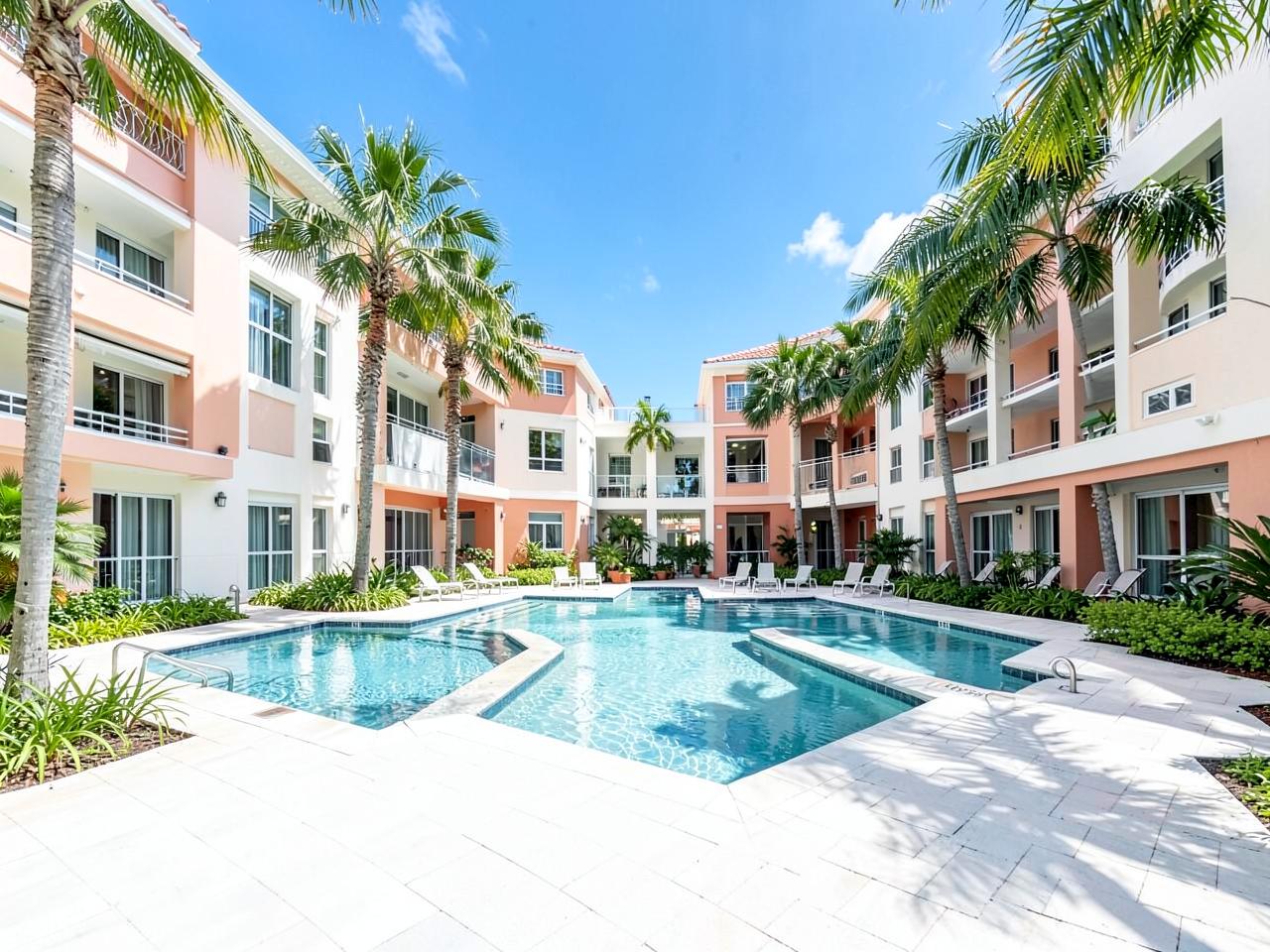 Florida condominium courtyard with pool and palm trees
